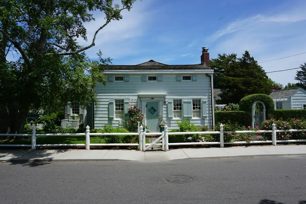 A house with a white picket fence along the street